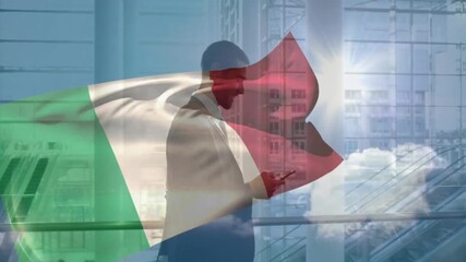 Using smartphone with Italian flag overlay, businessman in modern office - Powered by Adobe