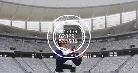 Athlete shifting stance and adjusting while overlay updating data in empty stadium securing catch - Powered by Adobe