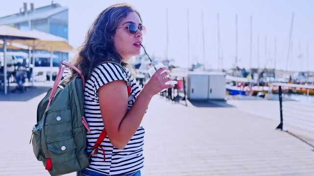 Female Traveler Holding Cold Drink On Sunny Day In Jaffa