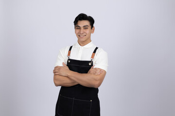 Confident chef posing with arms crossed in kitchen