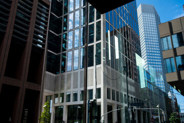 Frankfurt Germany finance business corporate skyscraper architecture office modern downtown street view with office entrance plaza and trees in sunlight