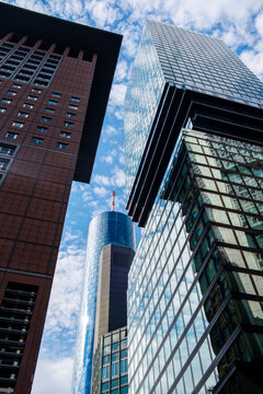 Frankfurt Germany finance business corporate skyscraper architecture office modern downtown dramatic upward view of towers against blue sky and clouds