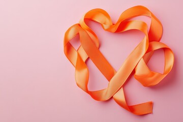 Orange ribbon forming heart shape on pink background
