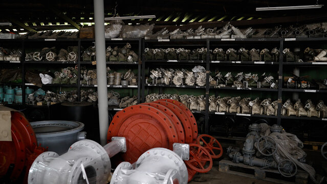 Industrial valves and plumbing parts on warehouse shelves