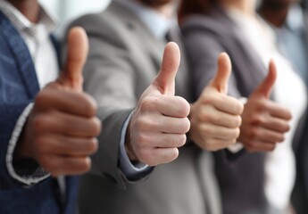 Team Unity and Success: Group Showing Thumbs Up in Supportive Gesture