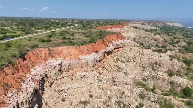 high-angle aerial perspective of Miradouro da Lua, showcasing the iconic eroded rock formations and deep orange earth tones