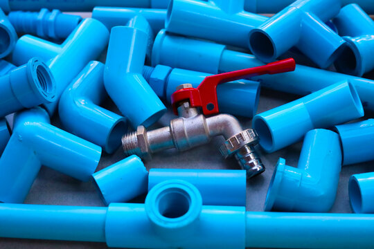 Assorted blue PVC connectors prepared for plumbing and piping work
