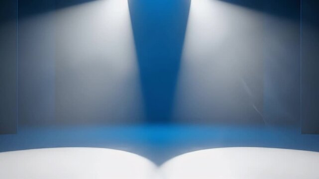 A pristine, empty blue stage is dramatically illuminated by two converging bright white spotlights, casting distinct pools of light onto the floor. The minimalist design and cool, gradient blue tones 