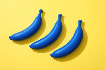 Bold Blue Bananas: A Vibrant Composition on a Sunny Yellow Backdrop