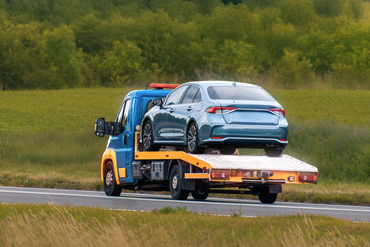 Professional towing service on empty rural road