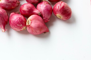 Red shallots on white background.