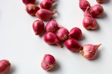 Red shallots on white background.