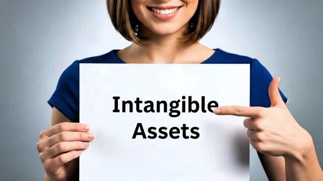 Video, close-up, employee's hand with document text &lsquo;Intangible assets&rsquo;, financial information, wealth, company, brands, patents, trademarks, knowledge, goodwill, licenses 