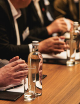 Diplomatic delegation meeting negotiation, group of men in business suits talking and discussing at conference, politicians debate and negotiate, businessmen have dialog, conversation on forum summit