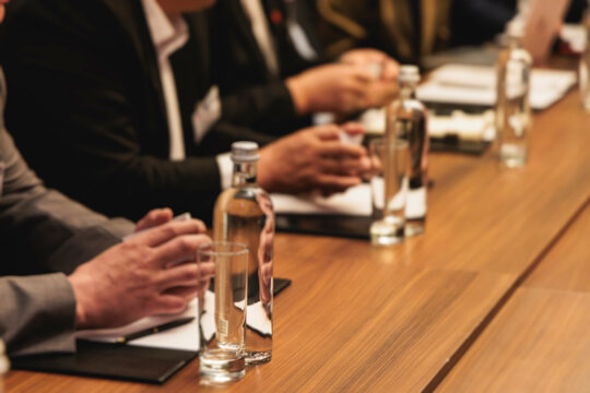 Diplomatic delegation meeting negotiation, group of men in business suits talking and discussing at conference, politicians debate and negotiate, businessmen have dialog, conversation on forum summit