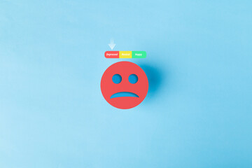 Red sad face icon with a mental health mood tracker showing depressed status on blue background. Concept for depression, burnout, psychological distress, and emotional wellness evaluation.