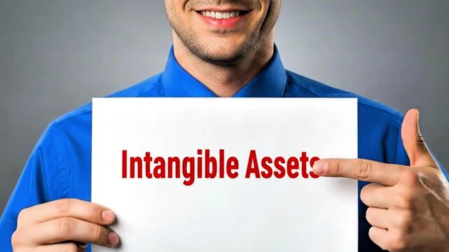 Video, close-up, employee's hand with document text &lsquo;Intangible assets&rsquo;, financial information, wealth, company, brands, patents, trademarks, knowledge, goodwill, licenses 