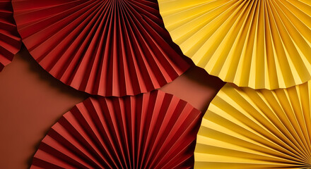 Vibrant red and yellow paper fans on brown background
