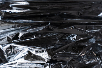 Horizontal layered foil texture with dark metallic reflections