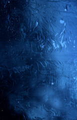 Vertical stock photo of patterns left by severe frost on a smooth surface
