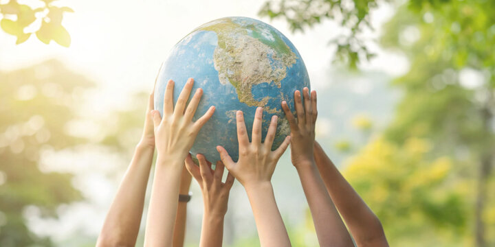 Environmental responsibility concept and collaboration in caring for the Earth with many hands working together to lift a model of the world