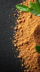 Close-up of Ground Spice with Green Leaves on Dark Background
