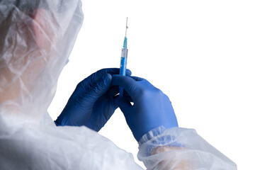 Person in protective gear holding a blue vaccination syringe ready for use