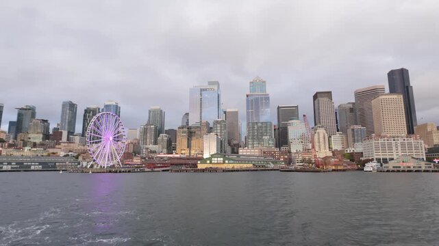 Gimbal wide shot of downtown Seattle as seen from a moving boat on the Salish Sea during early evening in Washington. 4K