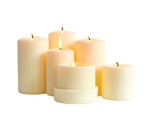 Glowing group of white candles with lit wicks, arranged close, on black background