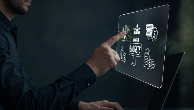 Man interacting with a futuristic holographic display showing financial and business management icons, representing digital budgeting and investment concepts. - Powered by Adobe