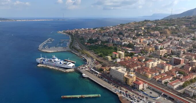 Villa San Giovanni, Italy. Aerial view of the Caronte Tourist ferry in the Mediterranean sea. It's the main means of transport for crossing the Strait of Messina, at horizon.