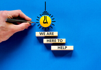 Support, help and we are here to help symbol. Concept words We are here to help on beautiful wooden...