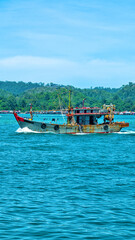 Fototapeta premium An old wooden fishing schooner goes out to catch fish and shrimp. Malaysia, South China Sea.