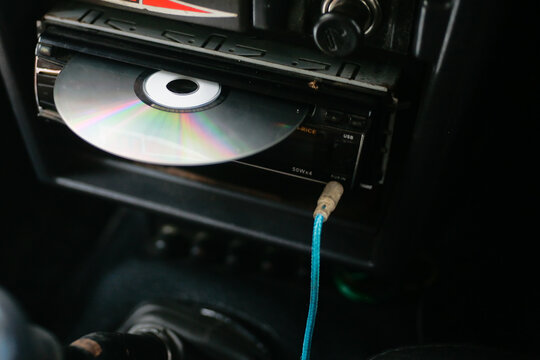 close up of dvd player with disc on head unit audio car