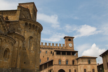 Fototapeta premium View of the historic square in medieval Castell'Arquato, Italy, showing the Romanesque church and Palazzo del Podestà with a clock tower