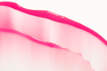 Cherry fuchsia pink colored make up cosmetic lip gloss or tint isolated on white background