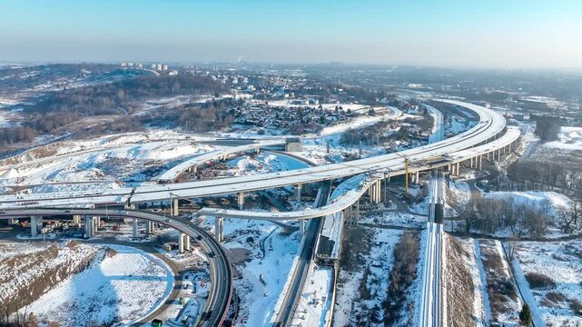 Krakow, Poland. Mistrzejowice highway interchange under construction in winter. Last fragment of motorway beltway around Krakow and joining S7 from Warsaw to A4. State in January 2026. Aerial 4K video