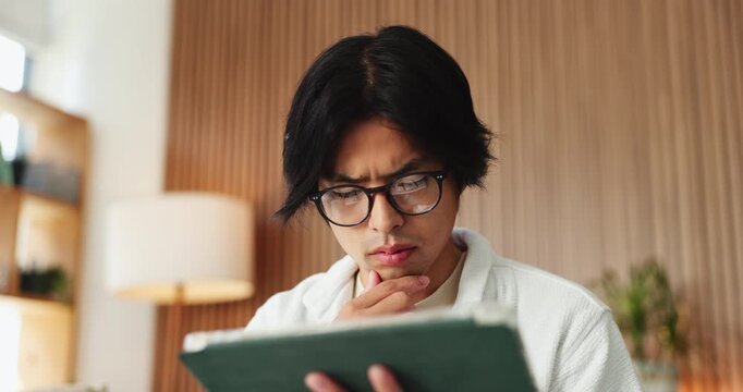 Remote work, think or man with tablet for editing, check aesthetic feedback or website maintenance idea. Low angle, reflection or Asian person with tech in home, project planning or system revision