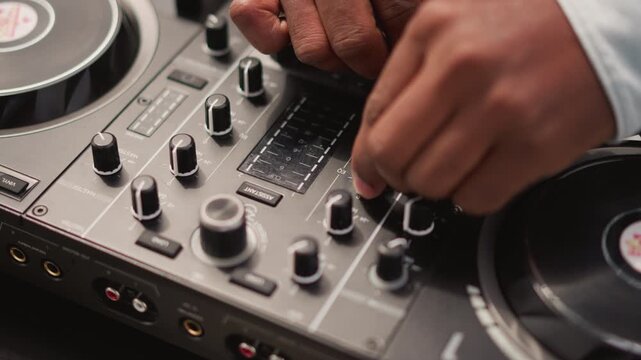 hands adjusting mixer knobs on controller during live street DJ set, closeup on turntable and fader, warm ambient lighting, tactile finger movements, precise beatmatching and scratch technique, urban