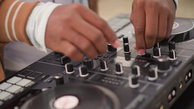 DJ mixing skills showcased outside, Casual disc jockey adjusting controls in open air environment, An informal DJ skillfully mixes tracks while managing equipment outdoors amid nature