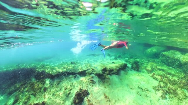 Underwater view of woman swimming in Pointe du Bout beach of Martinique, French Antilles in caribbean of France