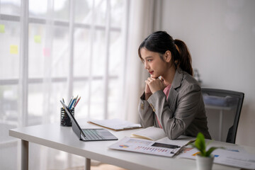 Businesswoman working from home office using tablet and analyzing charts