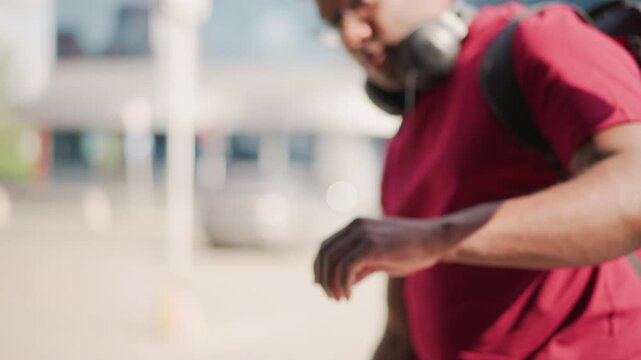 black man leaning into car trunk checking backpack and headphones after outdoor performance weary yet focused soft sunlight urban parking backdrop slow cinematic pans candid documentary vibe