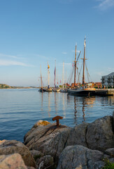Fototapeta premium Lindesnes, Norway - July 24 2025: Panoramic view of sailboats docked in harbor.