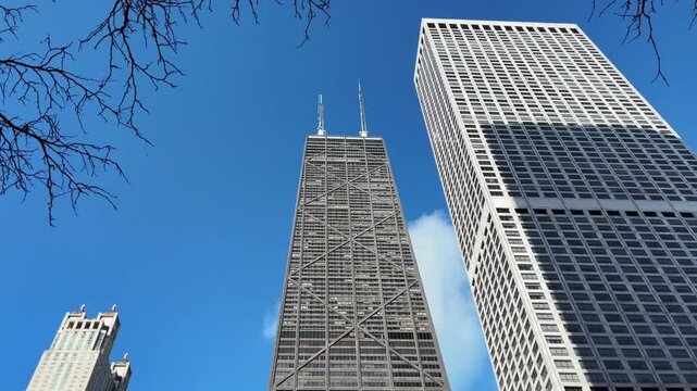 An upward view of 875 N. MIchigan, formerly the Hancock Building, and other skyscrapers in downtown Chicago.