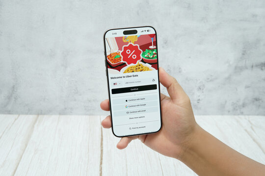 Rawang, Selangor, Malaysia - &lrm;January 21, 2026 - Hand holding smartphone displaying Uber Eats mobile food delivery application interface on screen.