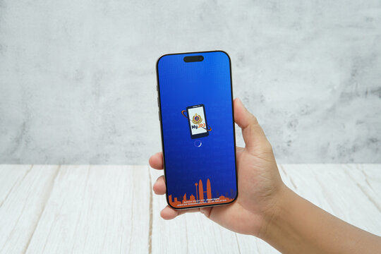 Rawang, Selangor, Malaysia - &lrm;January 21, 2026 - Hand holding smartphone displaying MyJPJ Malaysia mobile application interface on screen.