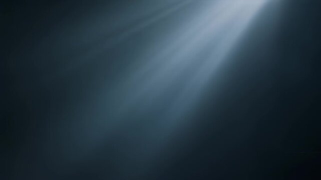 A dark, moody image featuring beams of light emanating from an upper right corner, creating a striking contrast