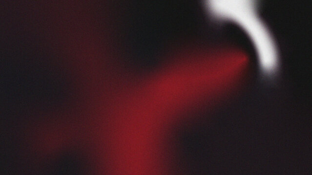 Abstract red and white blurred image with indistinct shapes and a dark background