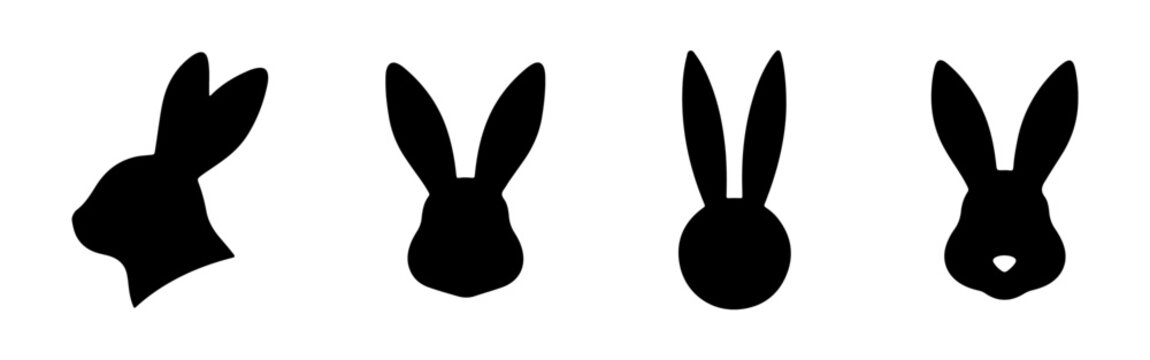 Set of four black rabbit head silhouettes. Vector illustration of bunny faces with long ears for Easter design.